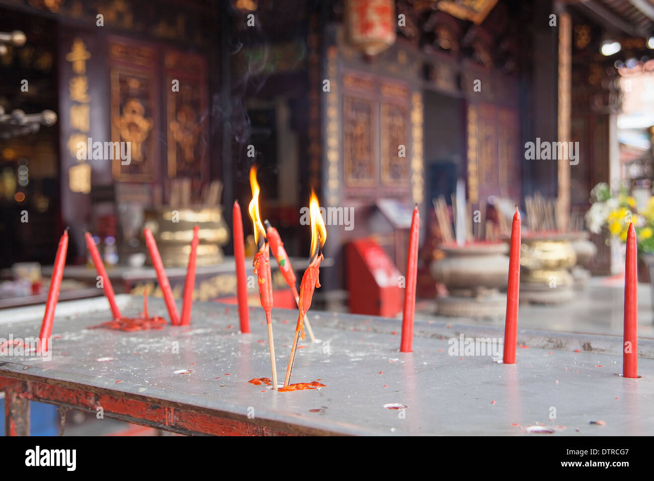 Burning Red Candles as Offerings to Chinese Gods at Chinese Temple in Malacca Malaysia Stock Photo