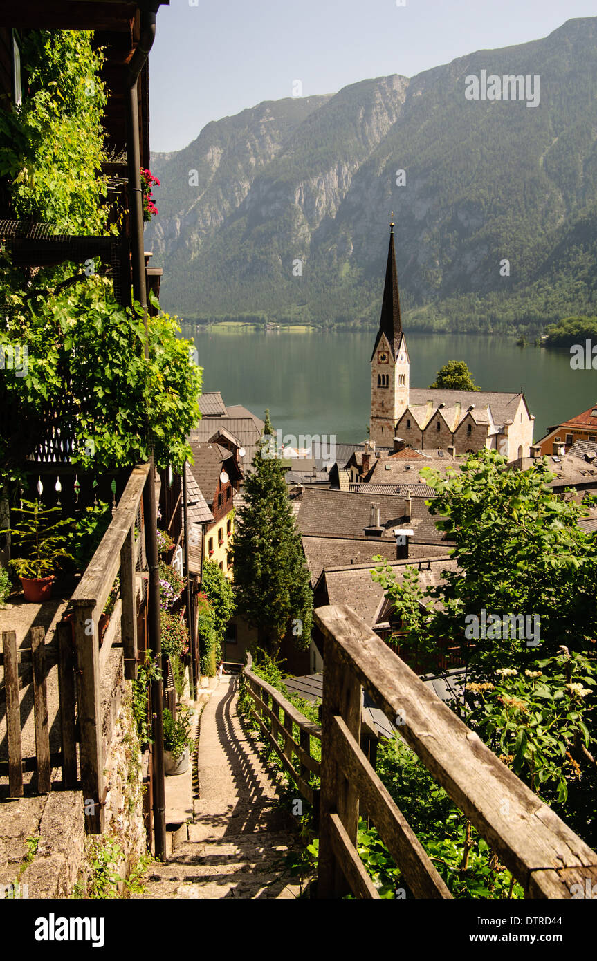 Stairs with wooden handrails down to the centre of Hallstatt in the midday Stock Photo