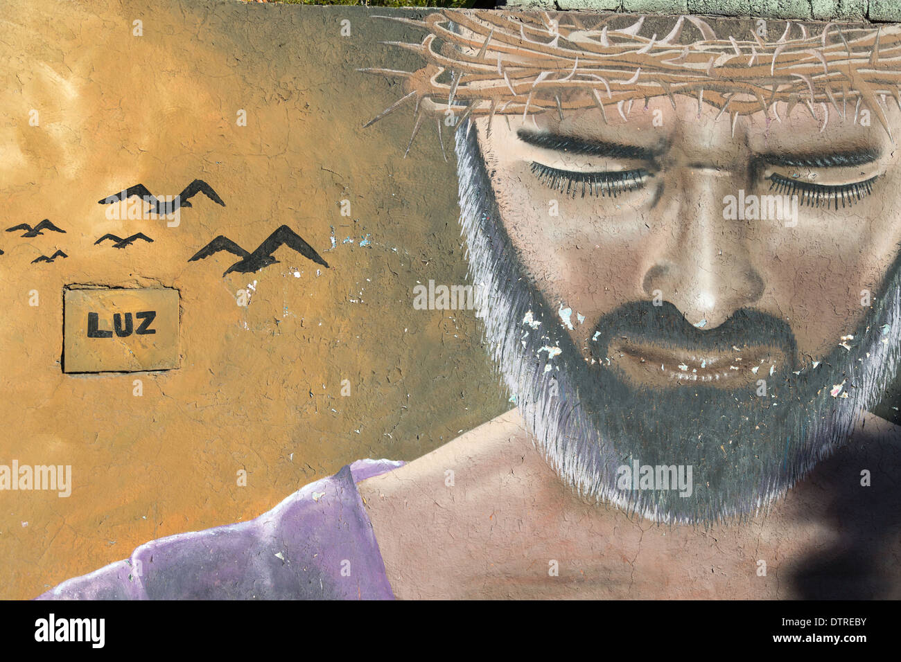 Street art depicting Jesus Christ with a crown of thorns along a street