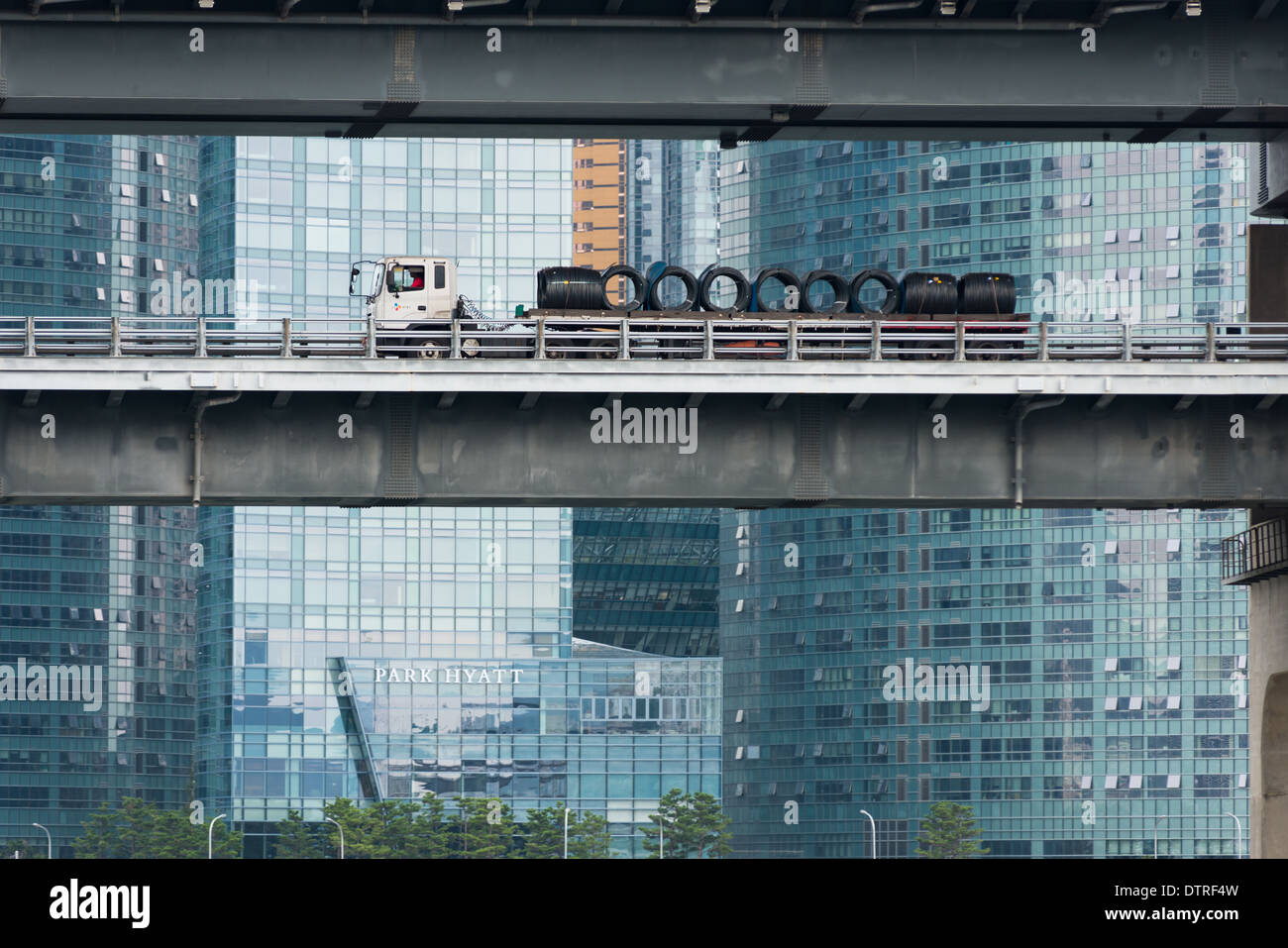 A lorry goes past the modern glass skyscrapers of Centum City, Pusan, South Korea Stock Photo