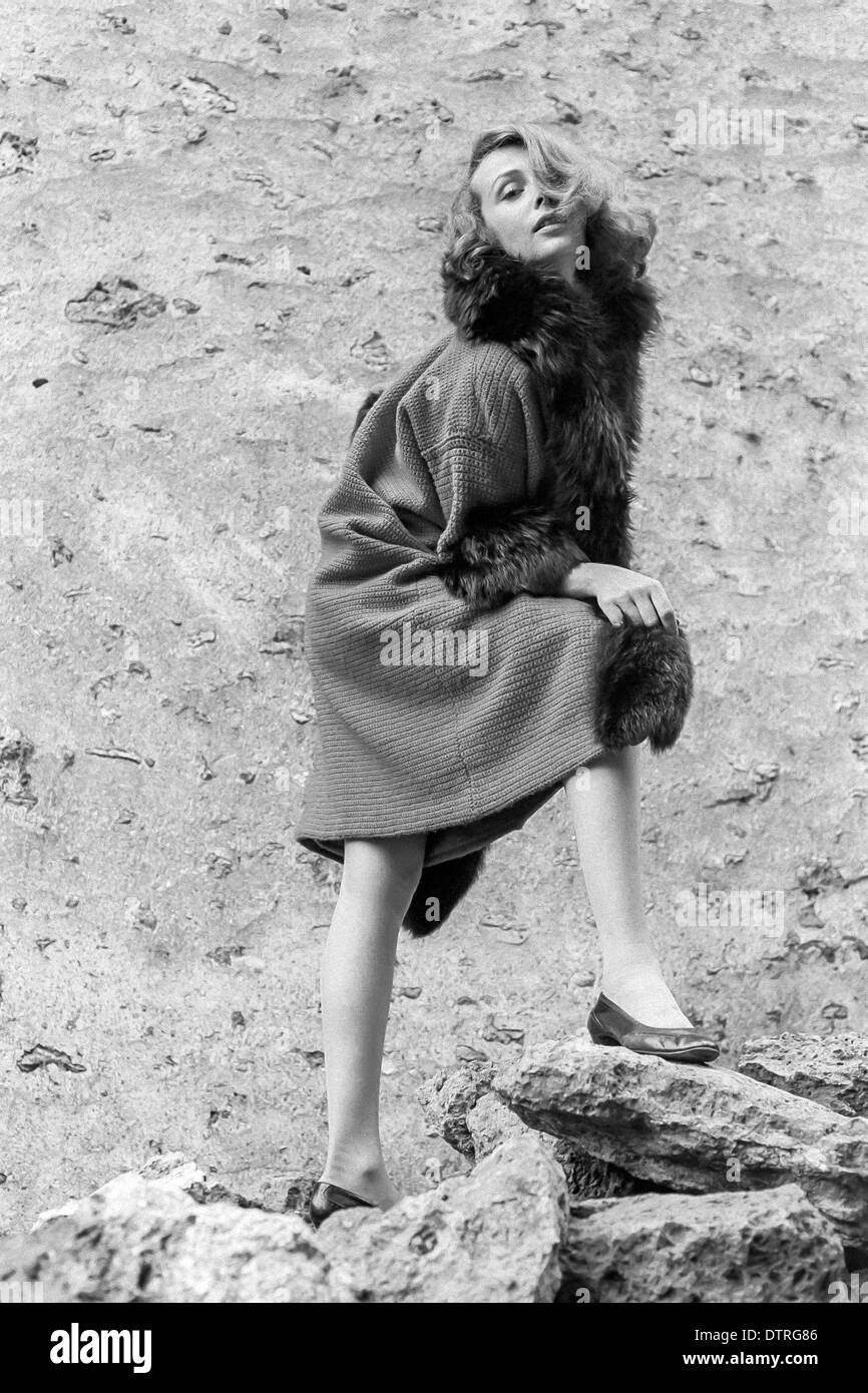 Sixties fashion model with fur coat Stock Photo