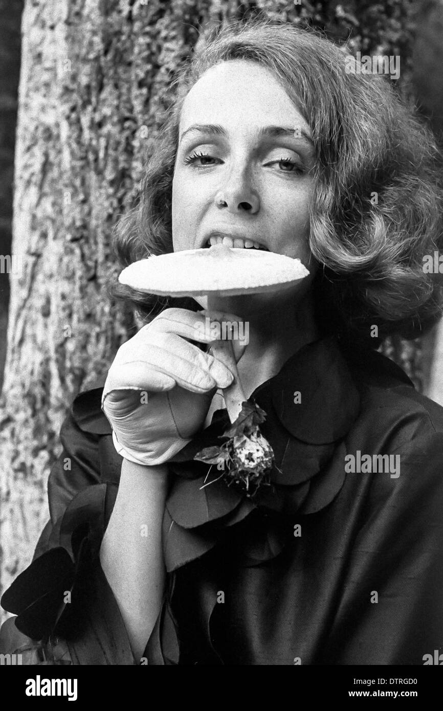 Sixties fashion model portrait biting a mushroom Stock Photo