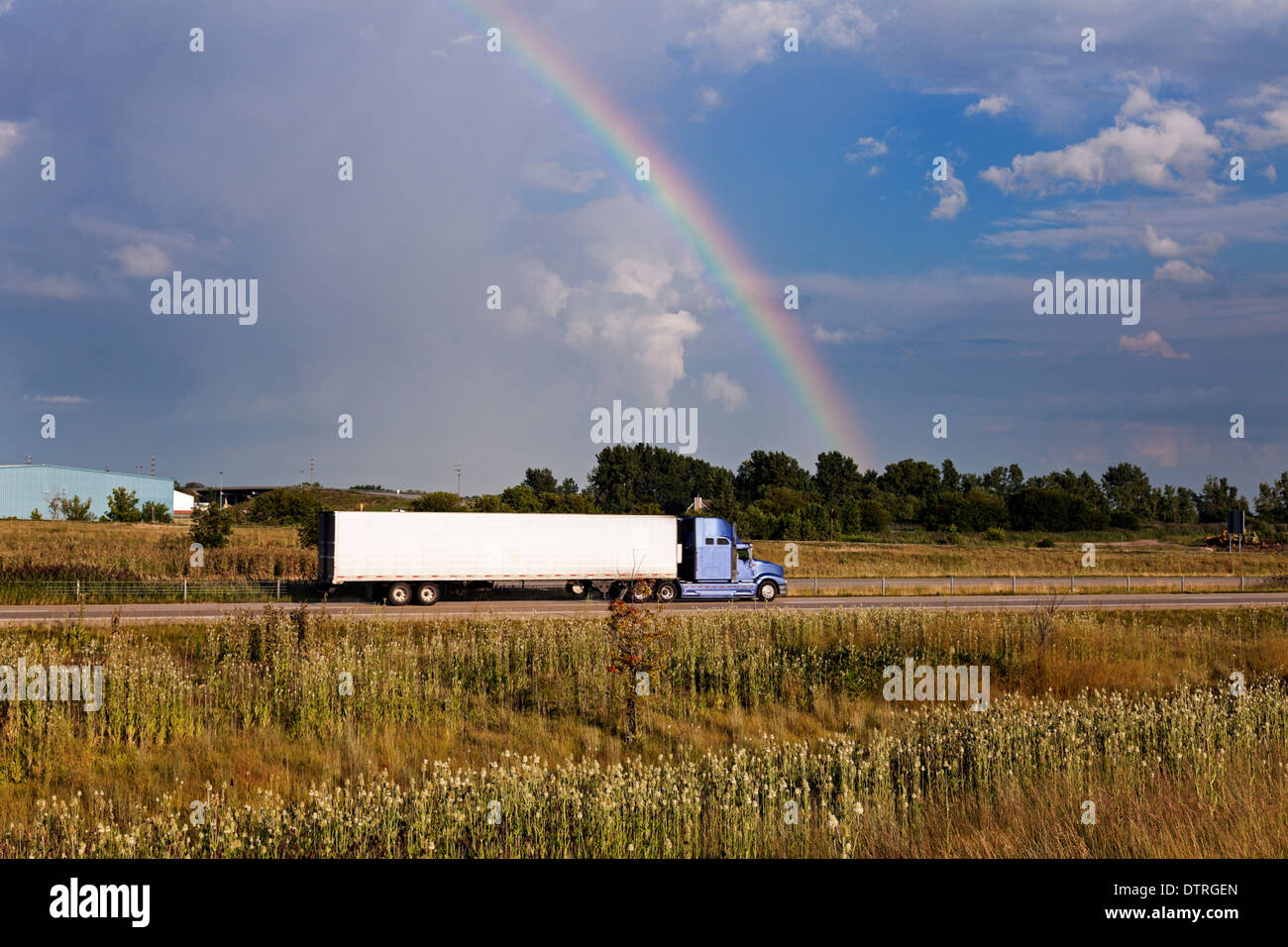Semi truck driving under the rainbow - Chicago, Illinois Stock Photo