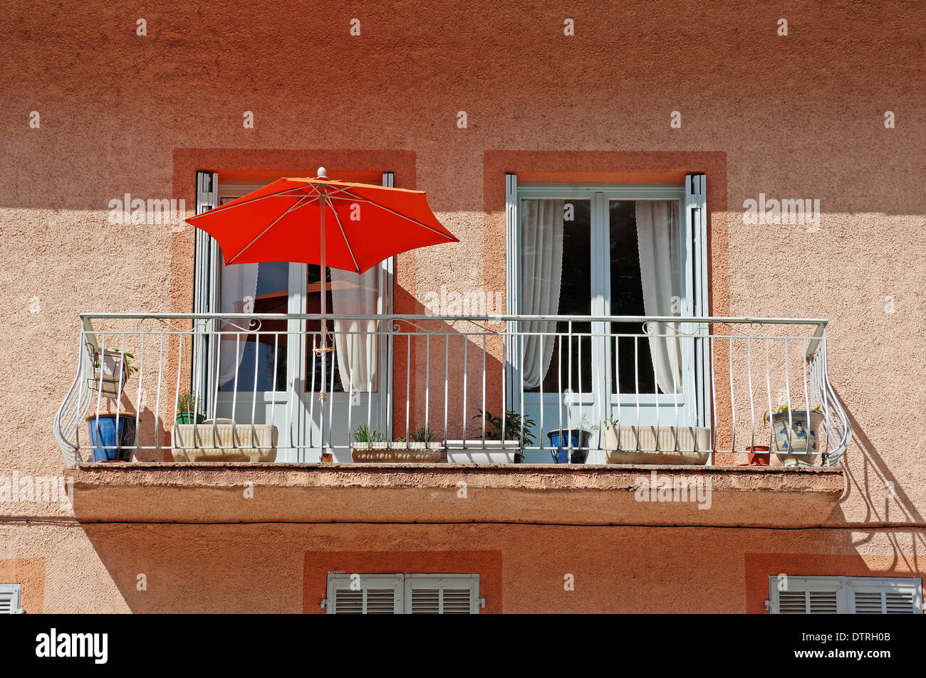 Balcony with sun umbrella, Guillaumes, Alpes-Maritimes, Provence-Alpes-Cote d'Azur, Southern France Stock Photo