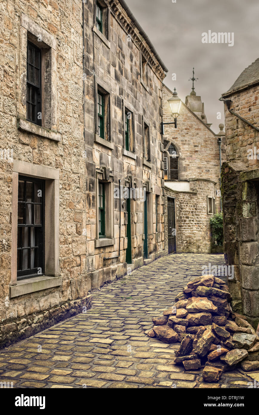 Old street with cobbled road and old fashioned street lamp Stock Photo