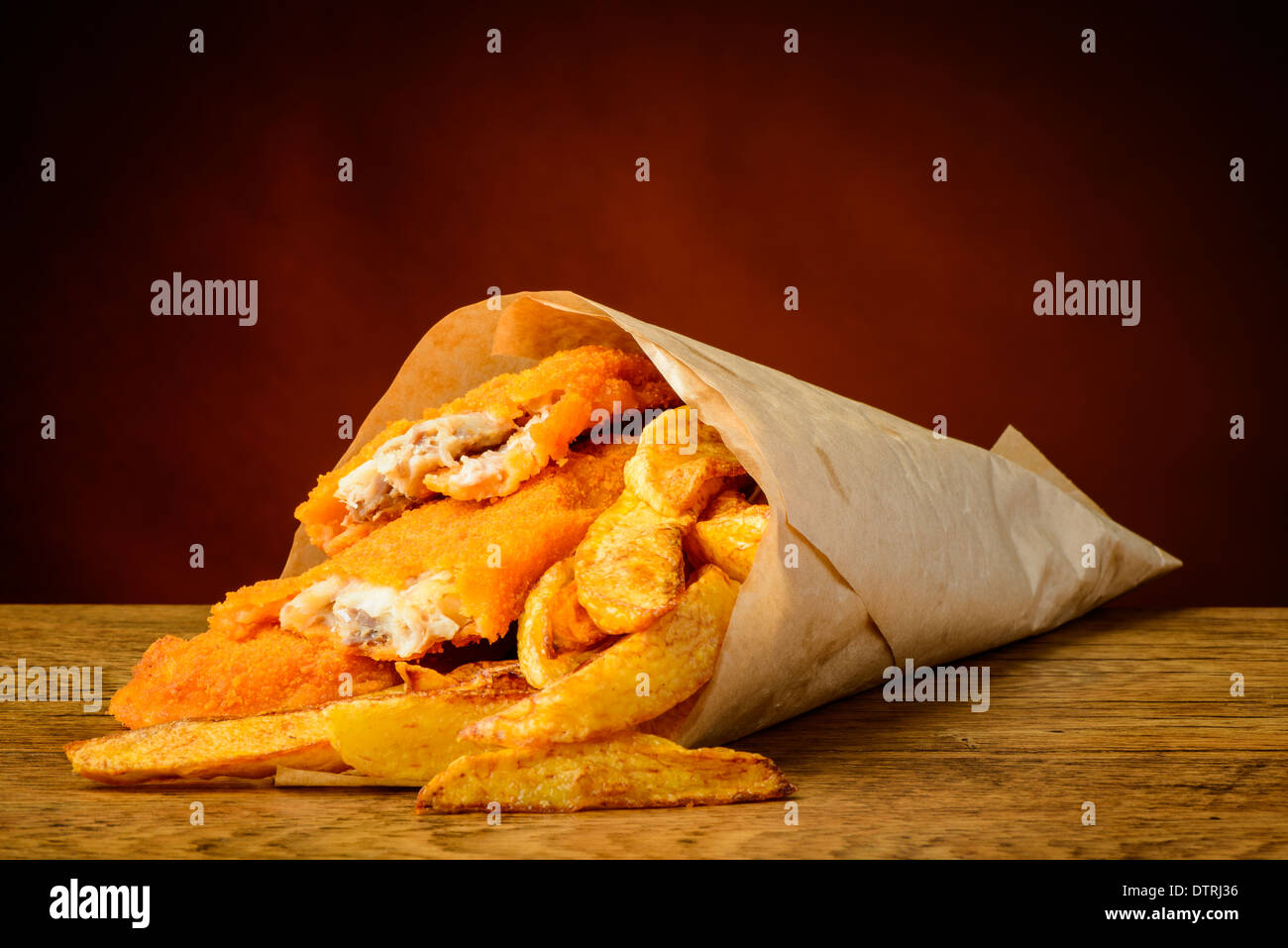 still life with traditional fish and chips wrapped in paper Stock Photo