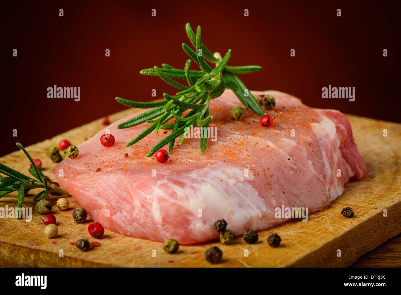 still life with raw steak, pepper and rosemary spices Stock Photo