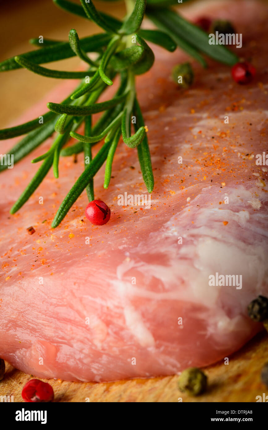 raw pork meat steak with rosemary and pepper Stock Photo