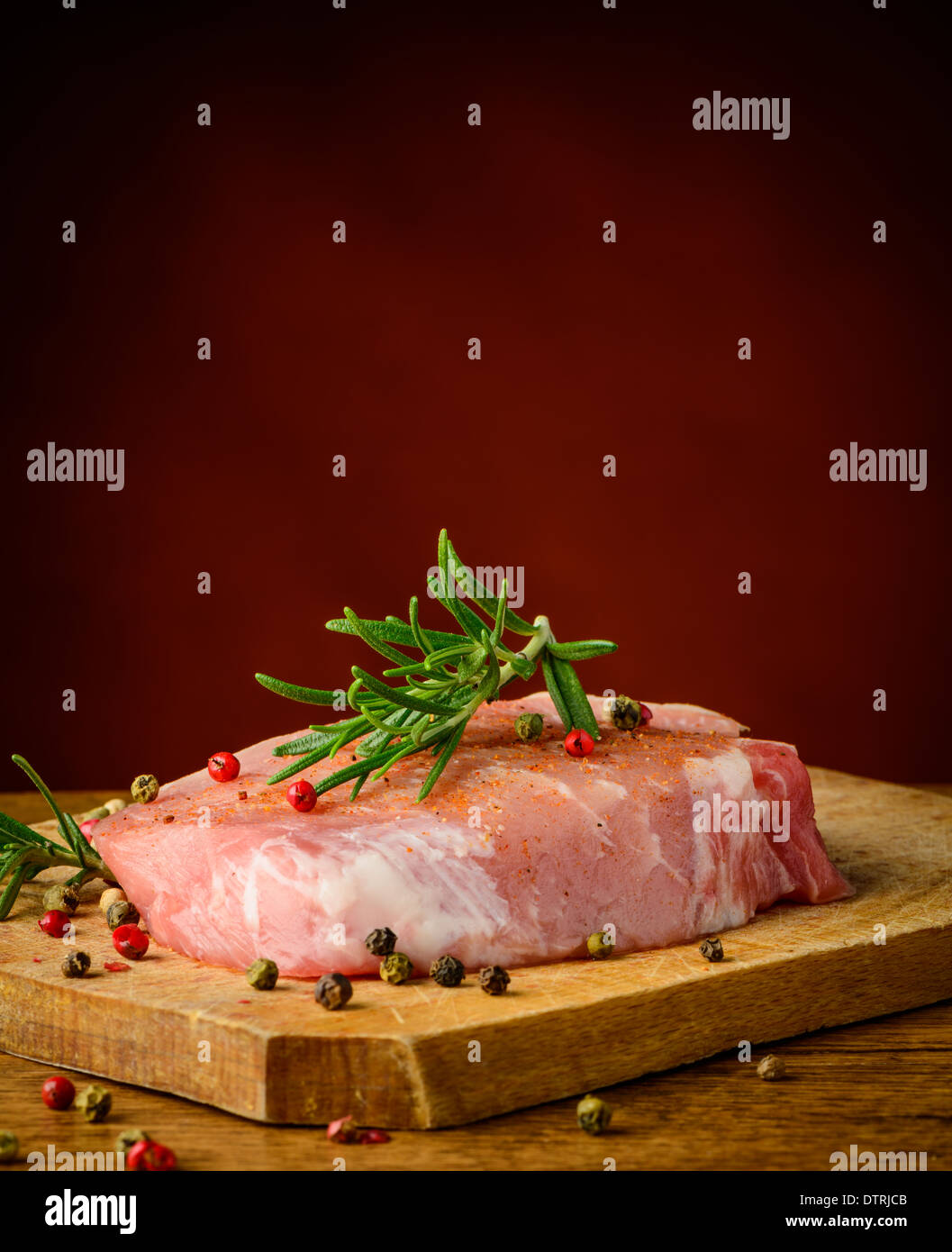 Raw pork steak, rosemary and pepper spices Stock Photo