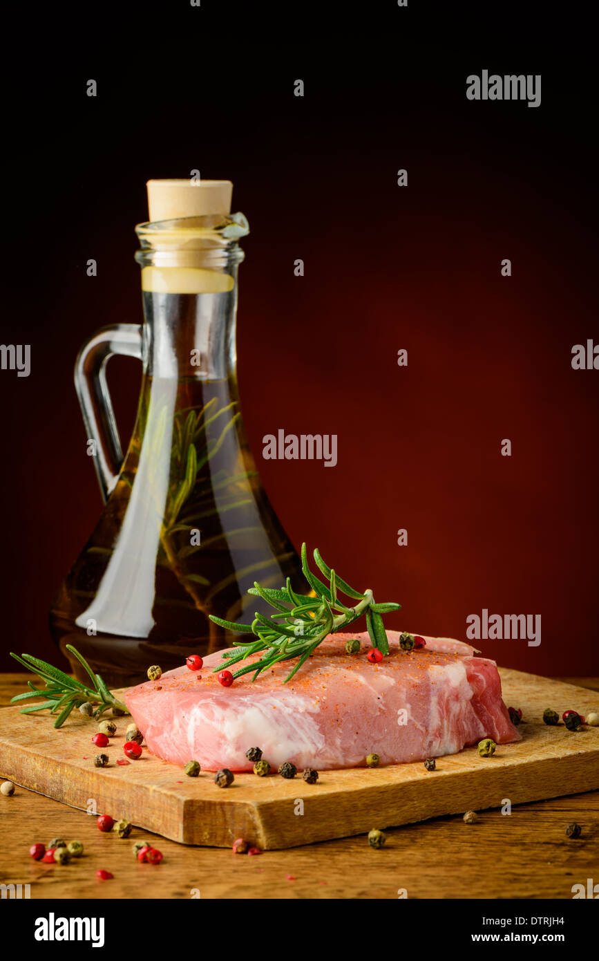 still life with raw pork meat steak, spices and olive oil Stock Photo
