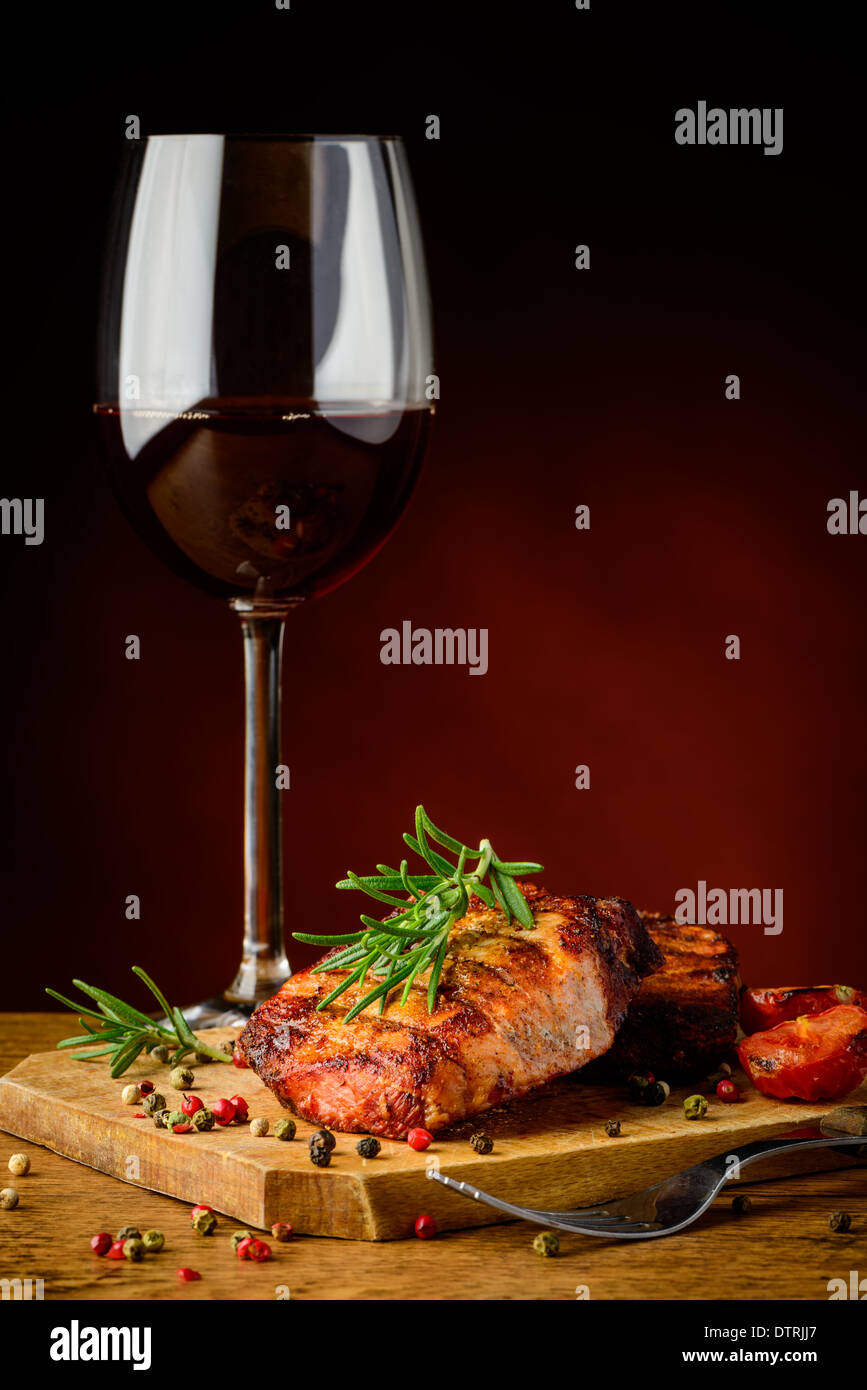 still life with beef steak, rosemary and glass of red wine Stock Photo