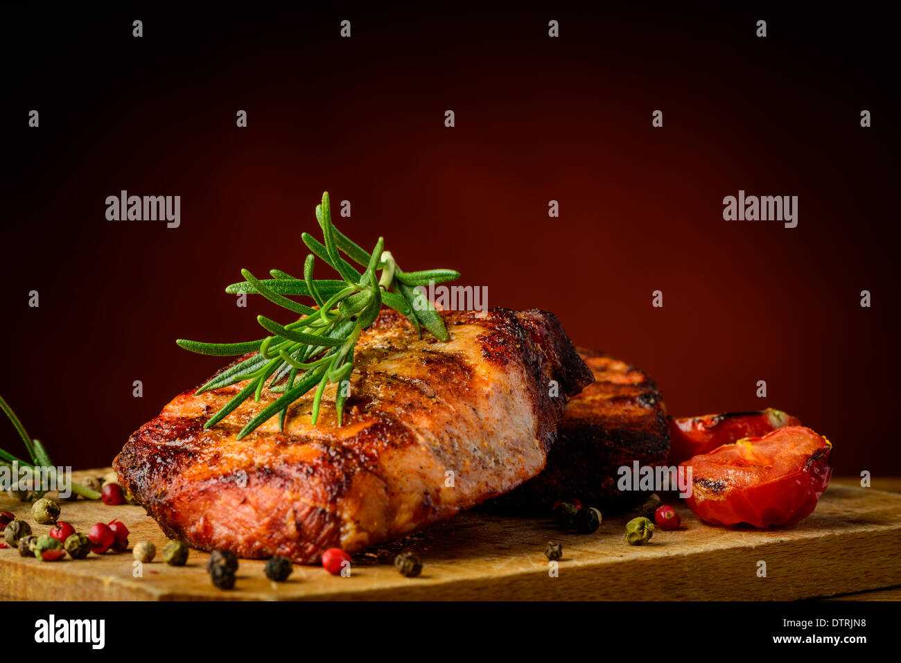 still life with grilled meat and rosemary herb Stock Photo