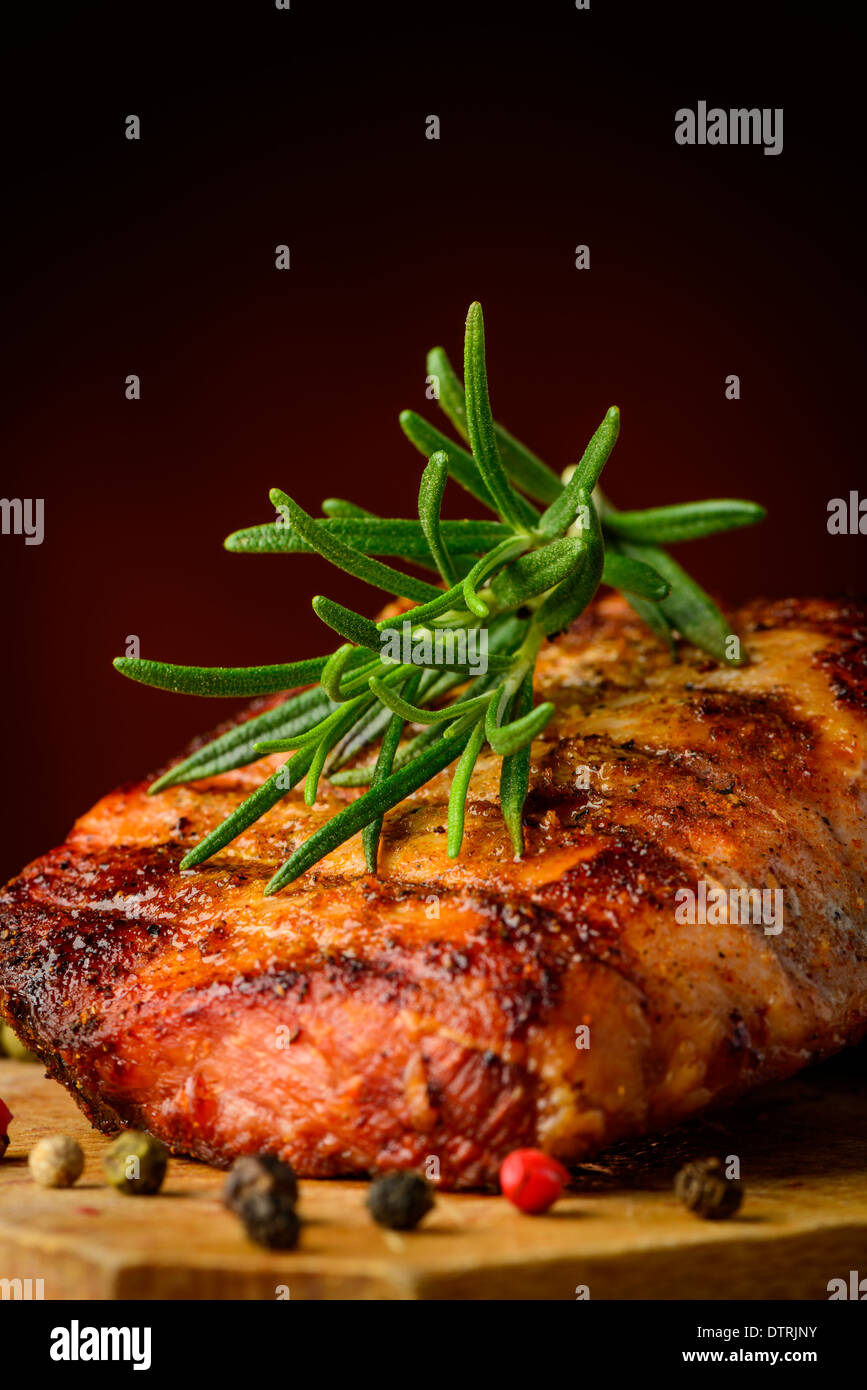 still life with grilled steak and rosemary herb Stock Photo