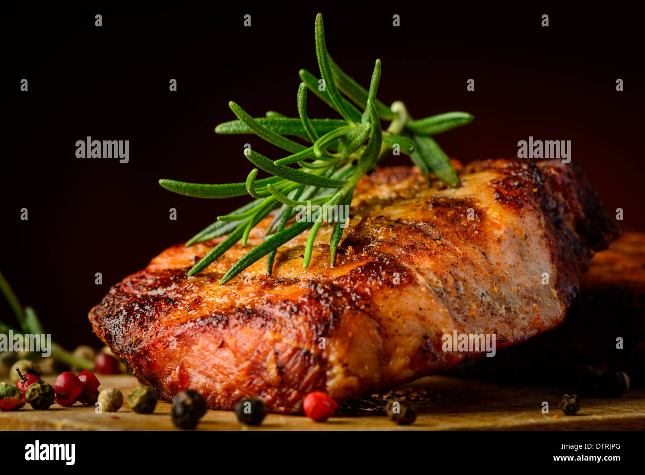 still life with grilled meat closeup detail and rosemary herb Stock Photo