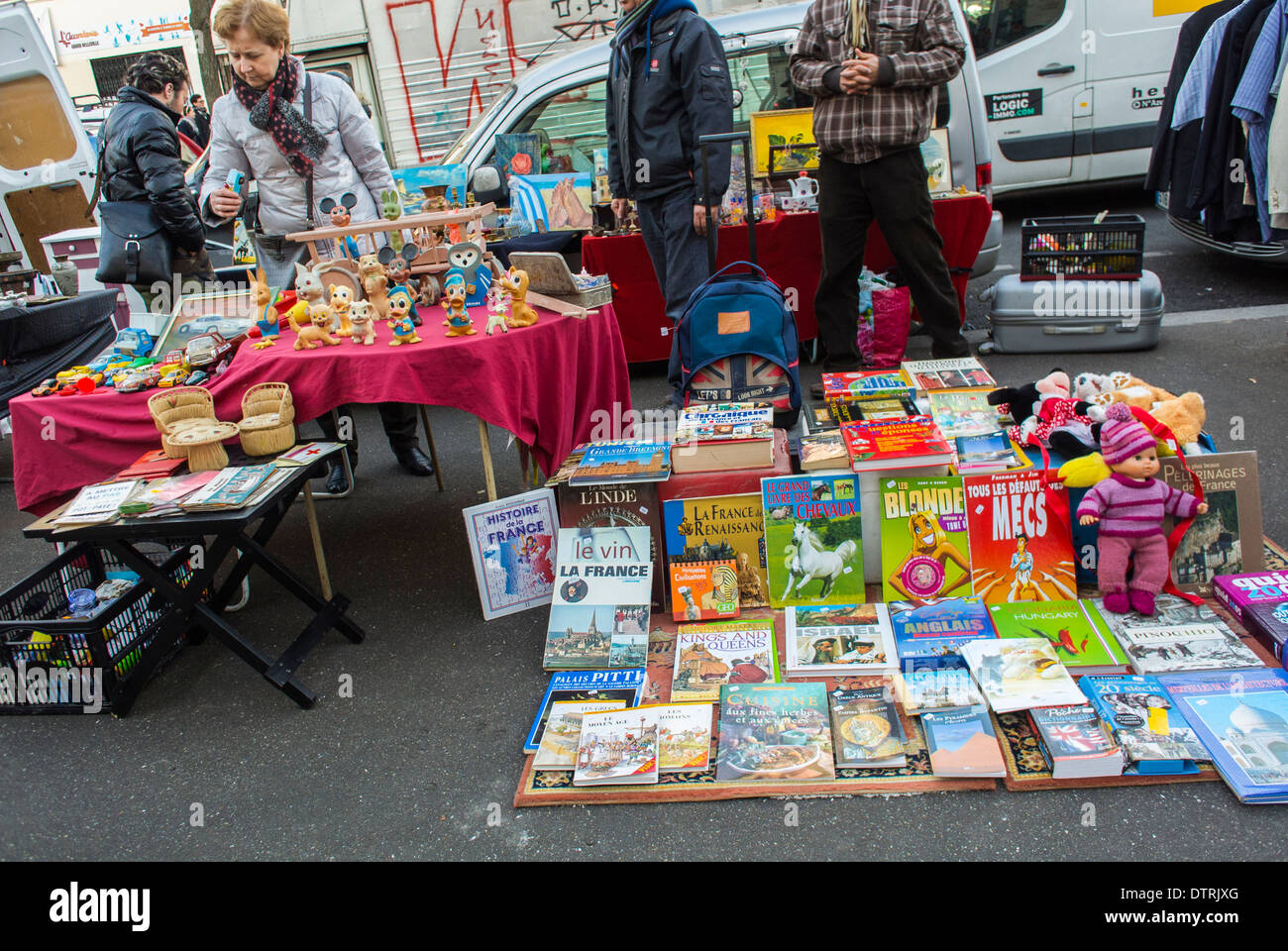 People shopping french flea market belleville childrens books display