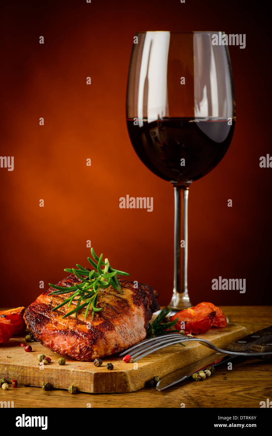 still life with grilled steak, rosemary and glass of red wine Stock Photo