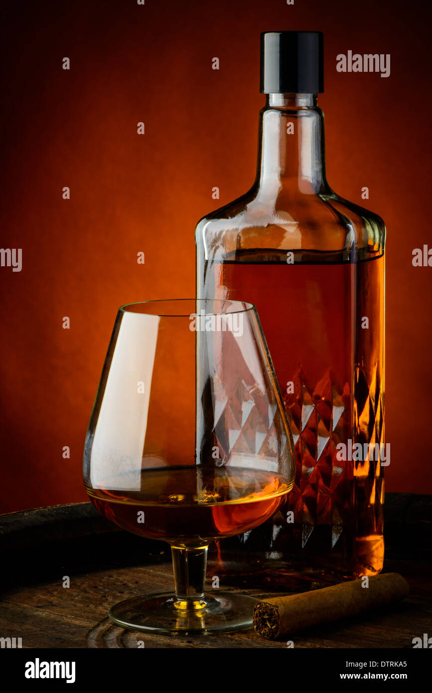 still life with brandy and cigar on a wooden barrel Stock Photo