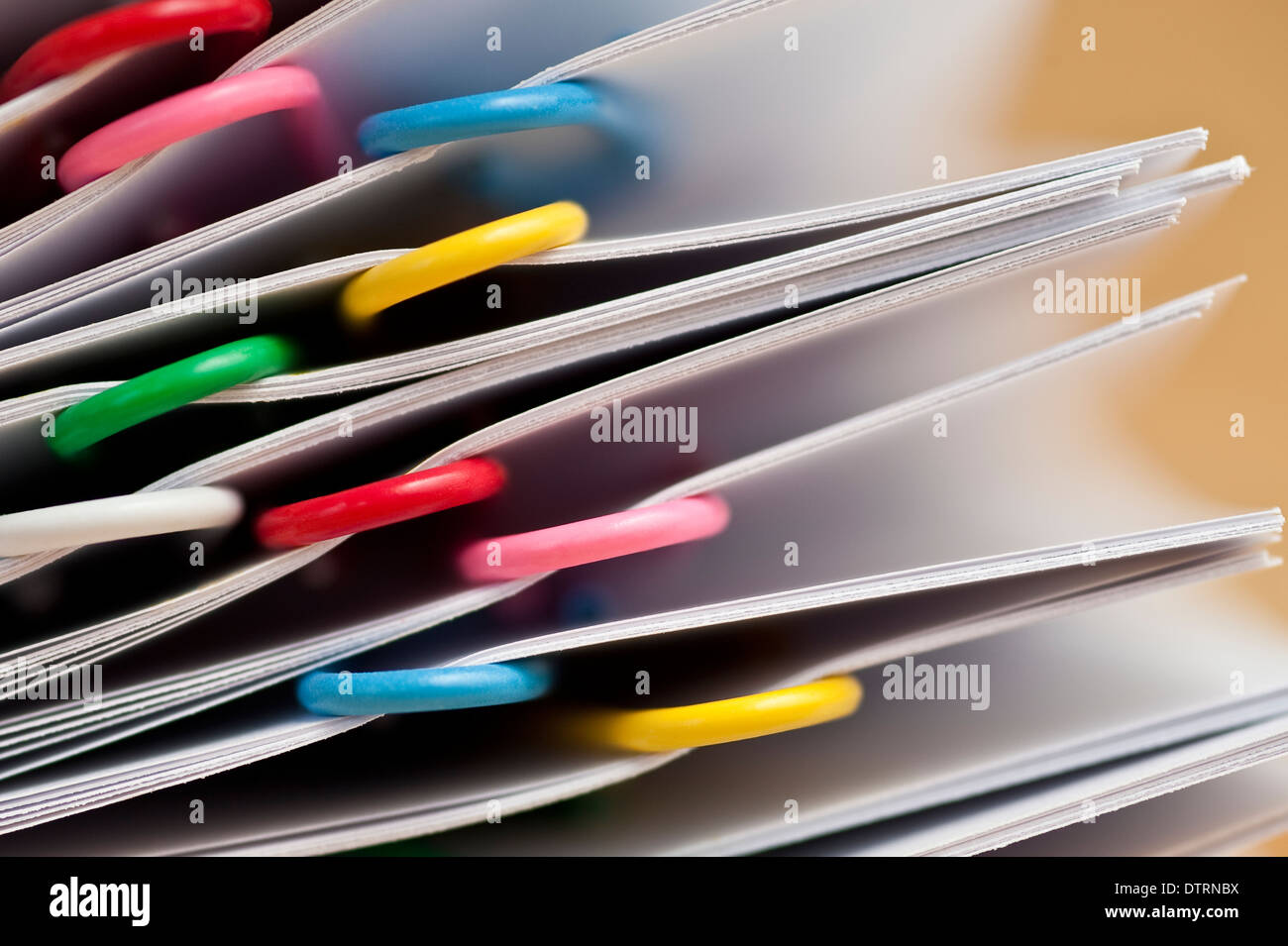 Documents stacked with multicolored paper clips closeups Stock Photo Alamy