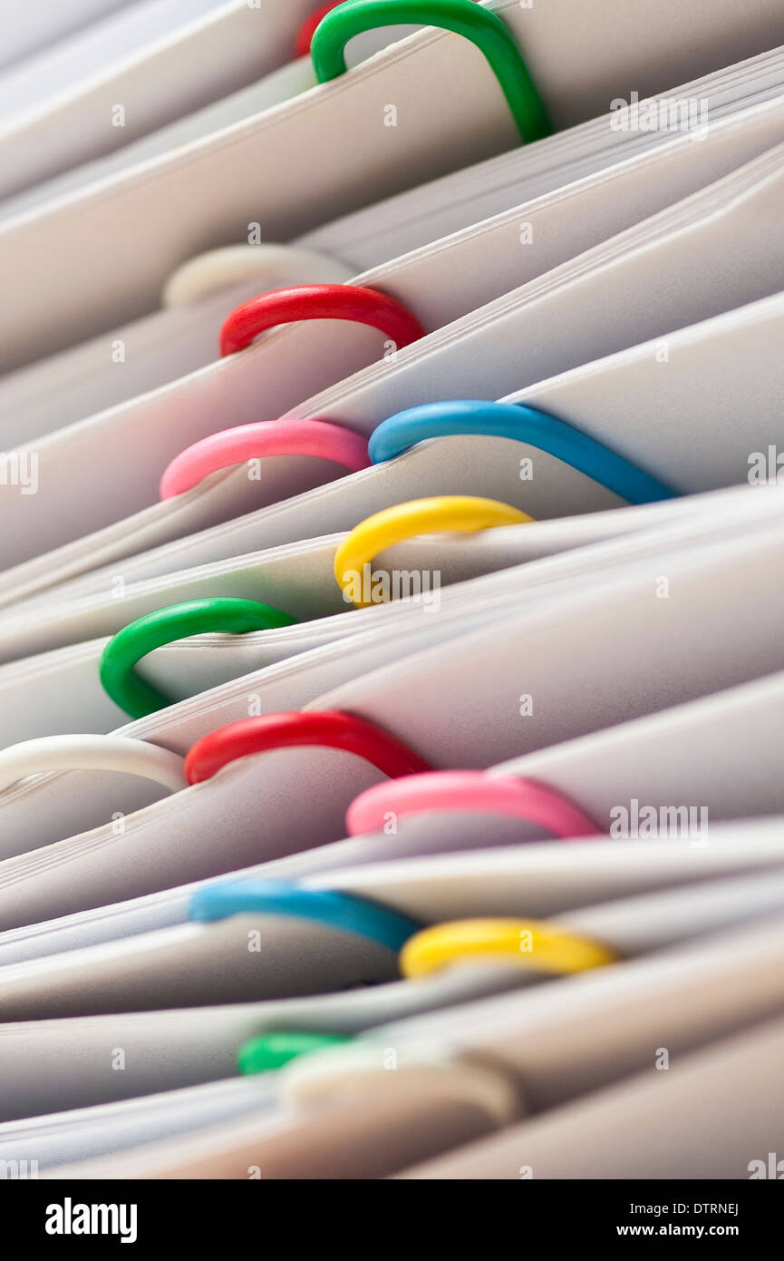 Documents stacked with multicolored paper clips closeups Stock Photo Alamy