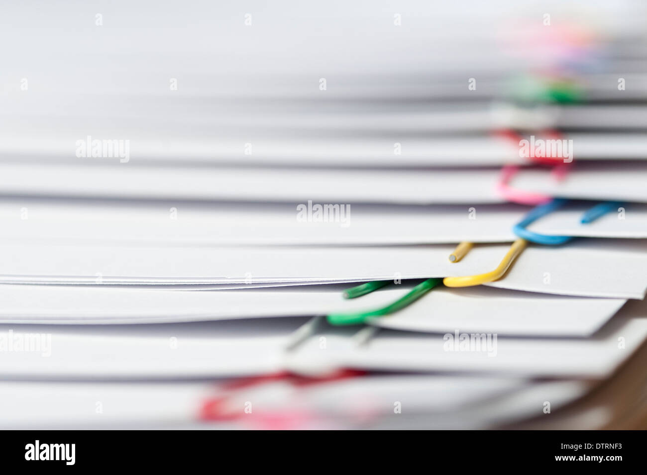 Documents stacked with multicolored paper clips closeups Stock Photo Alamy