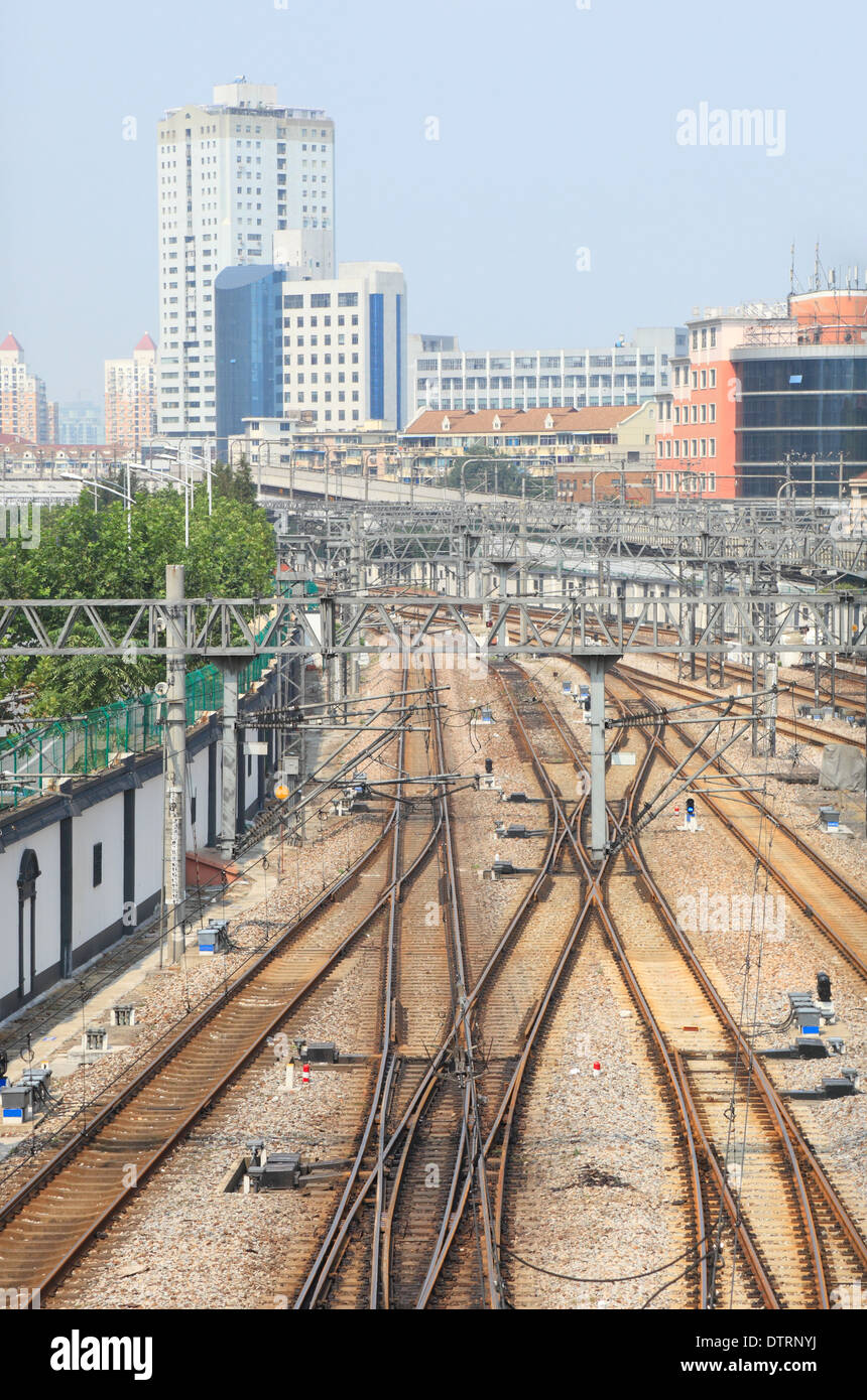 Rail road tracks with city buildings at distance Stock Photo Alamy