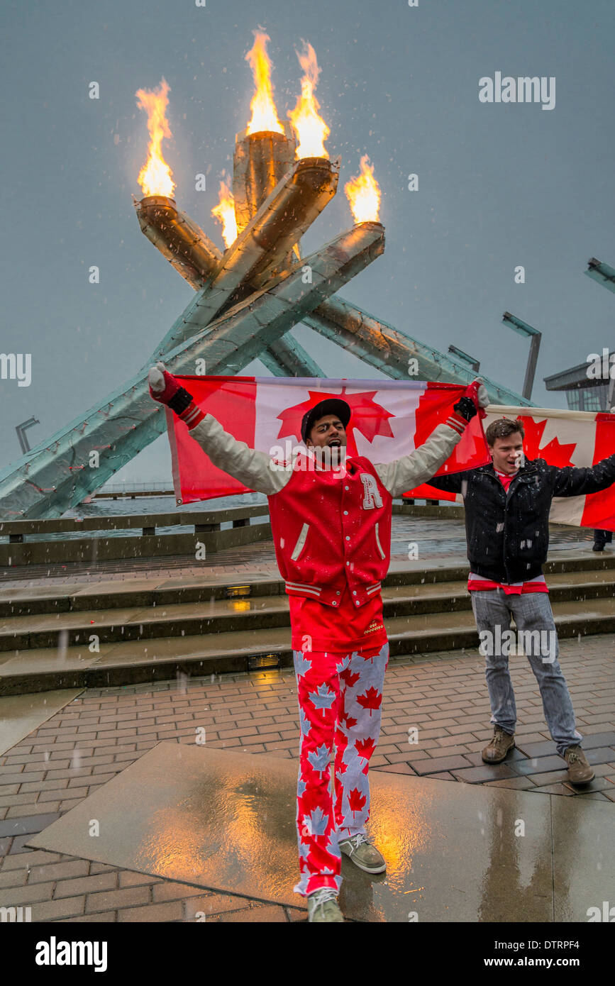Canadians celebrate the 2014 Olympic Hockey gold medals by gathering at the 2010 Olympic Cauldron in Vancouver. Stock Photo