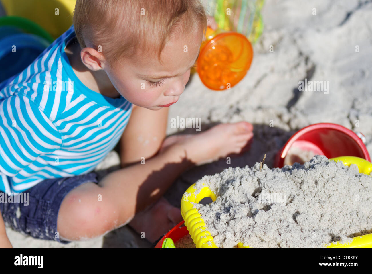 Child playing on the beach Stock Photo