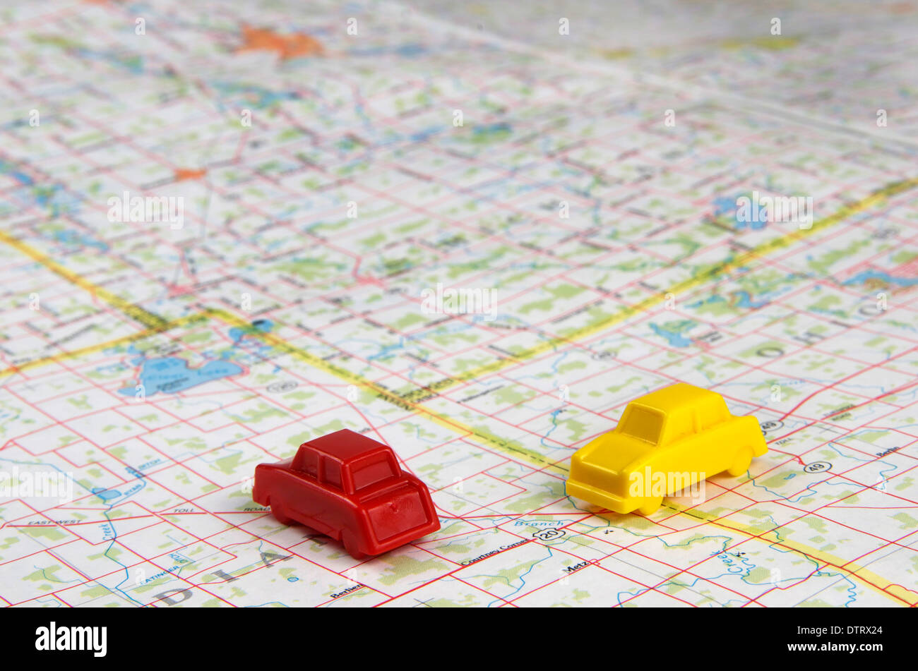 Red and yellow miniature cars intersecting on a map Stock Photo