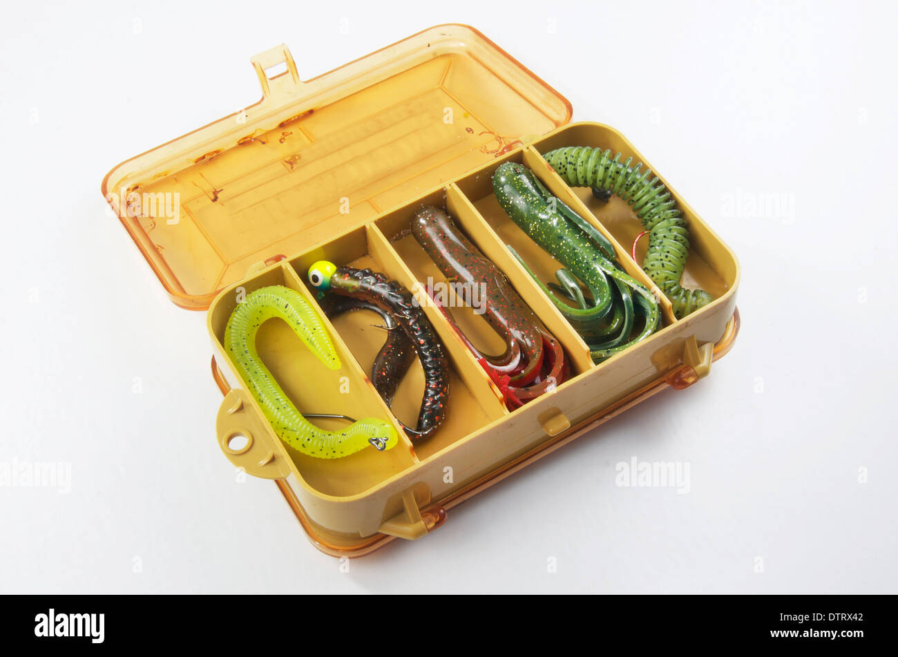 Bass bait, or old fishing tackle box with rubber worms and tubes. Stock Photo