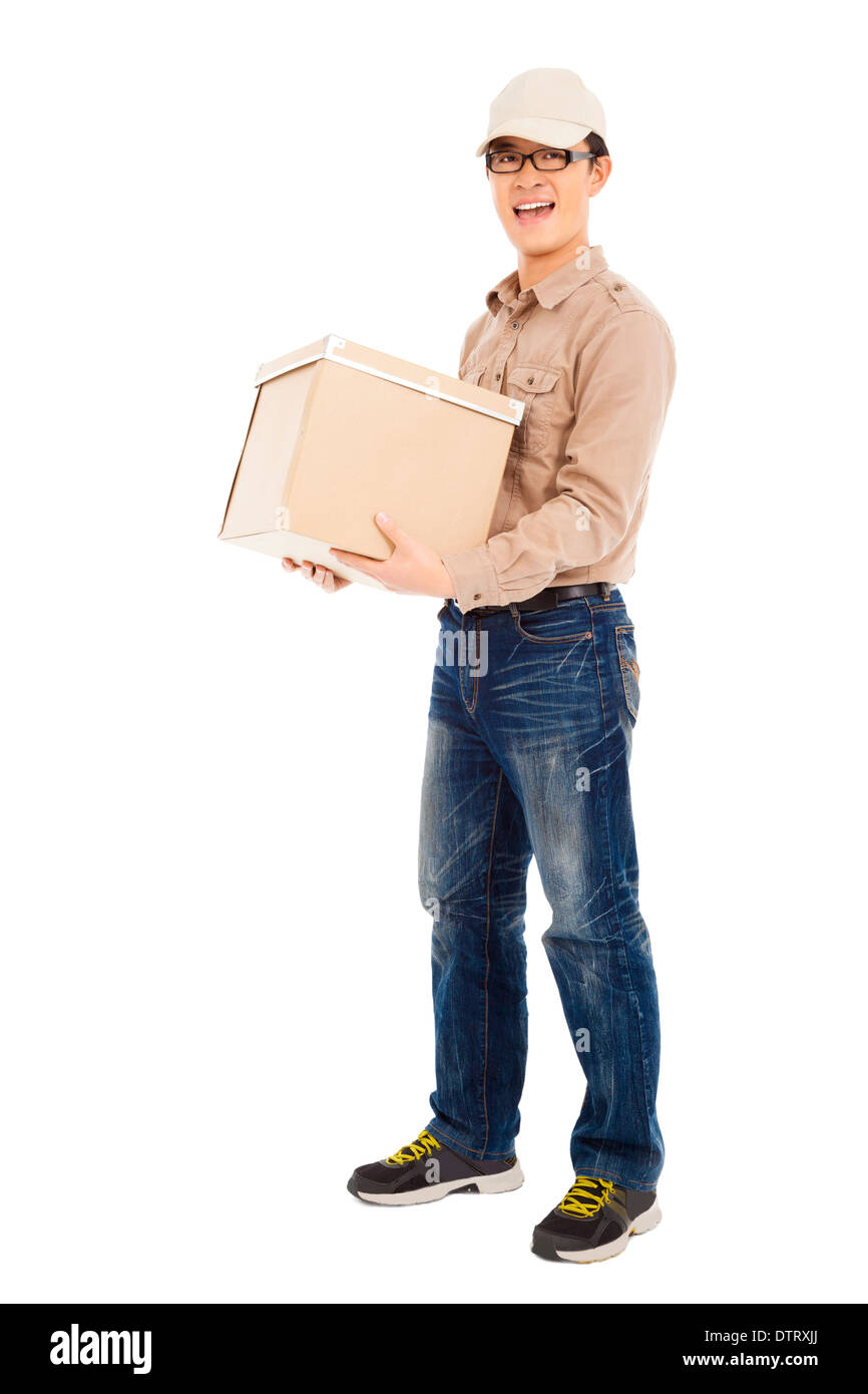 smiling delivery man holding parcel and standing in studio Stock Photo ...