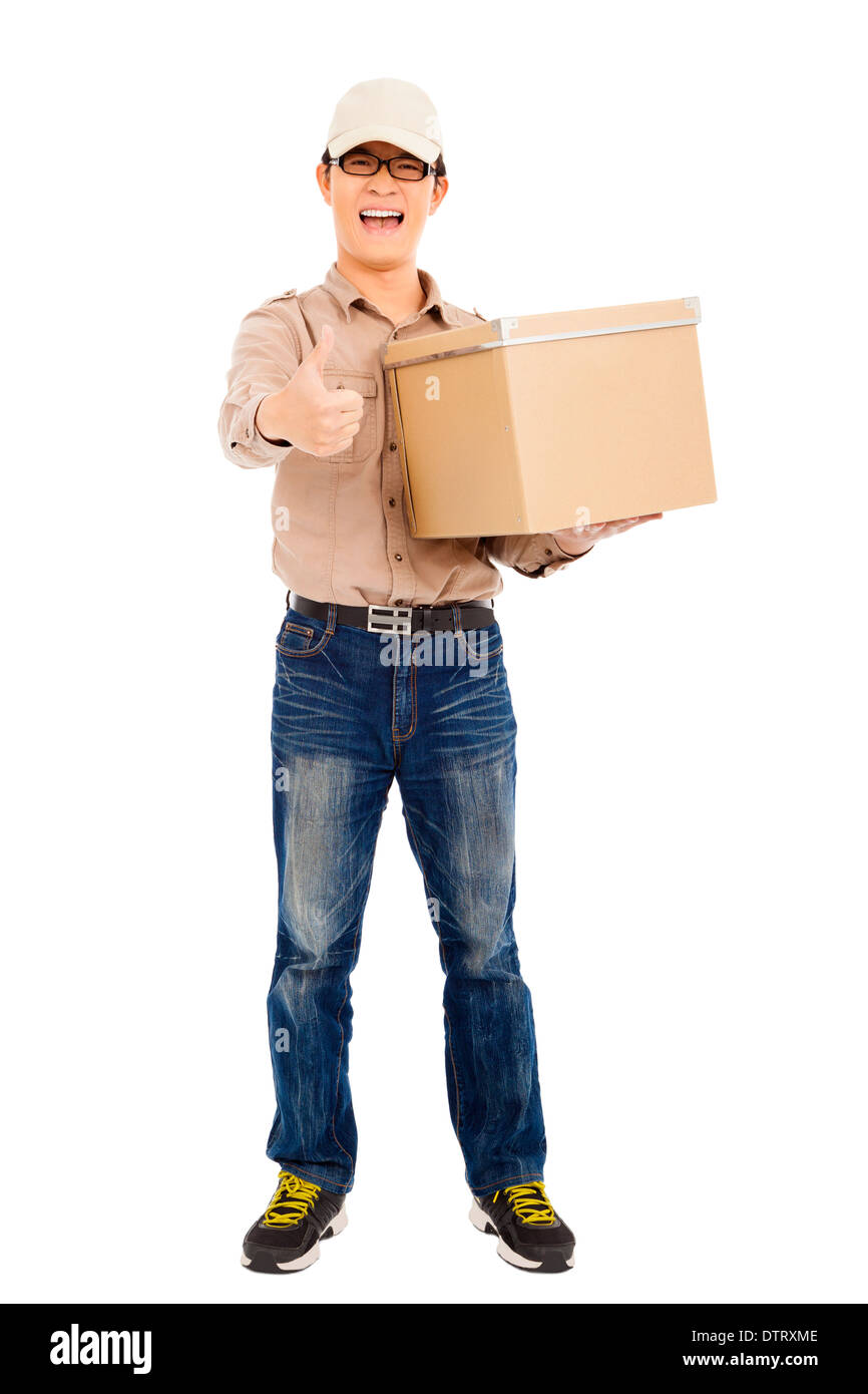 smiling  delivery man holding parcel and thumb up in studio Stock Photo