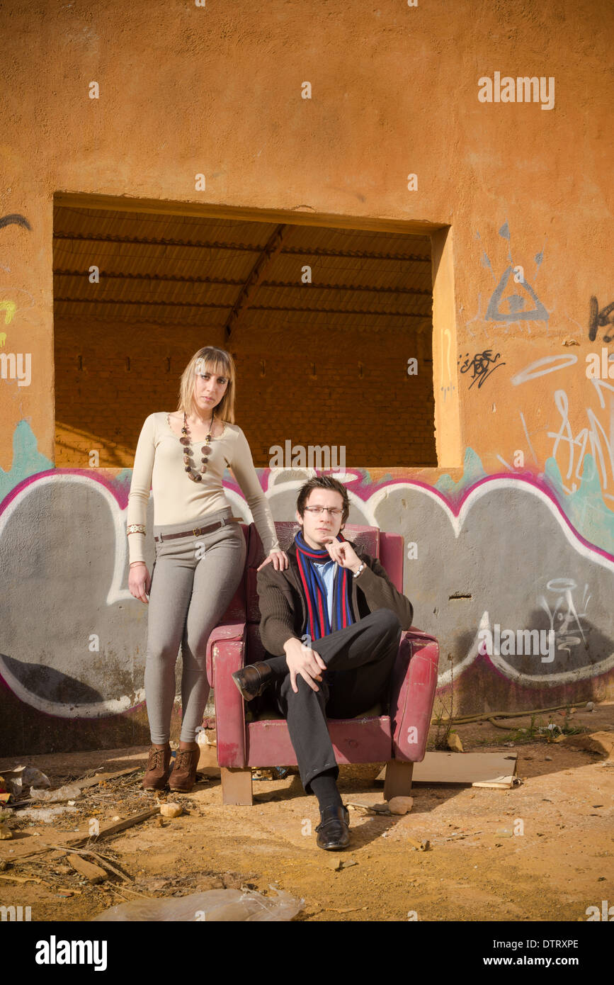 Posh looking people surrounded by industrial ruins Stock Photo