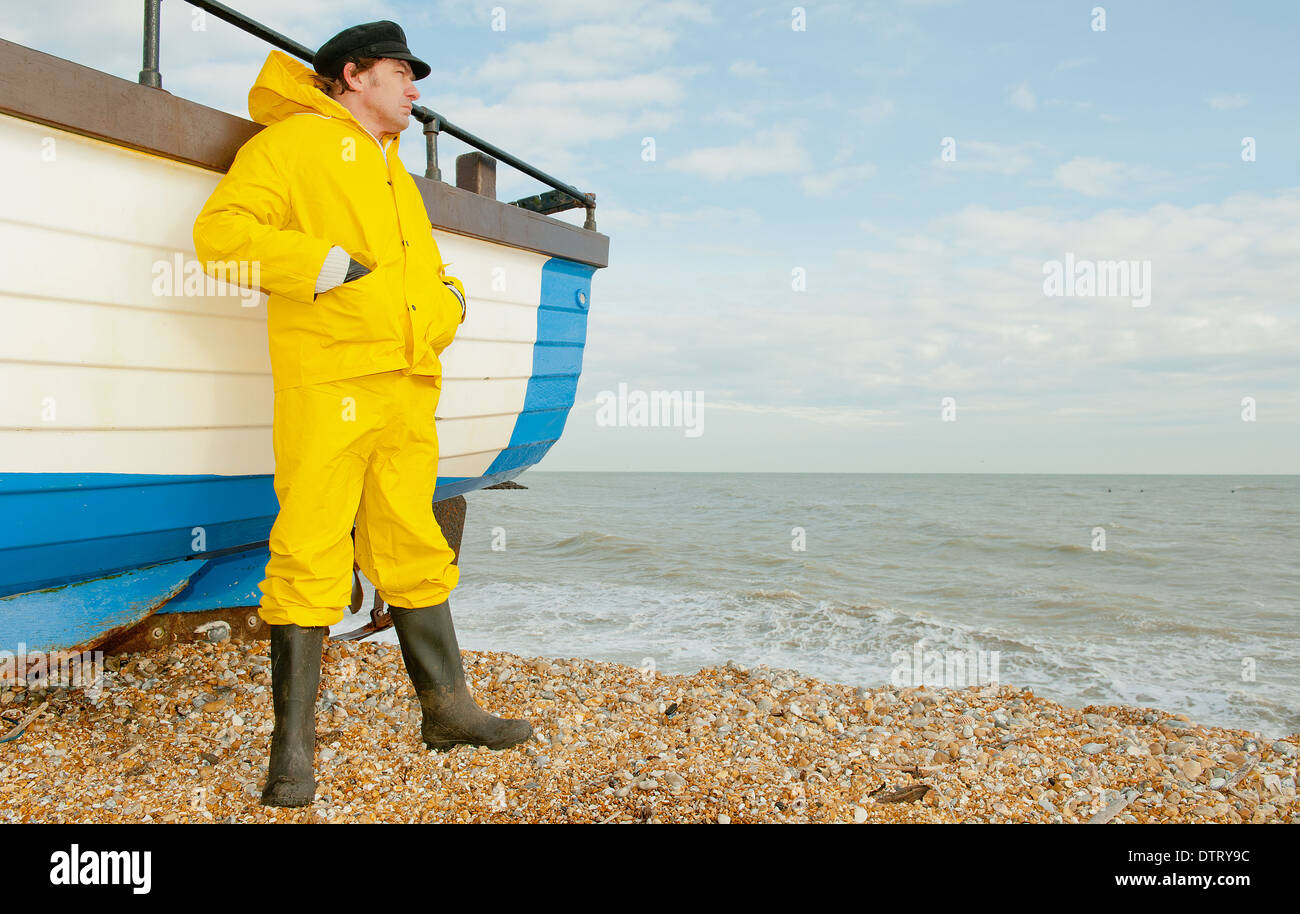 https://c8.alamy.com/comp/DTRY9C/fisherman-in-yellow-waterproofs-leaning-against-his-fishing-boat-and-DTRY9C.jpg