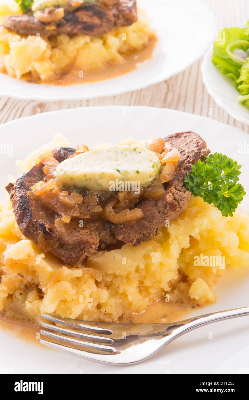 Spit roasts with braised onions Stock Photo