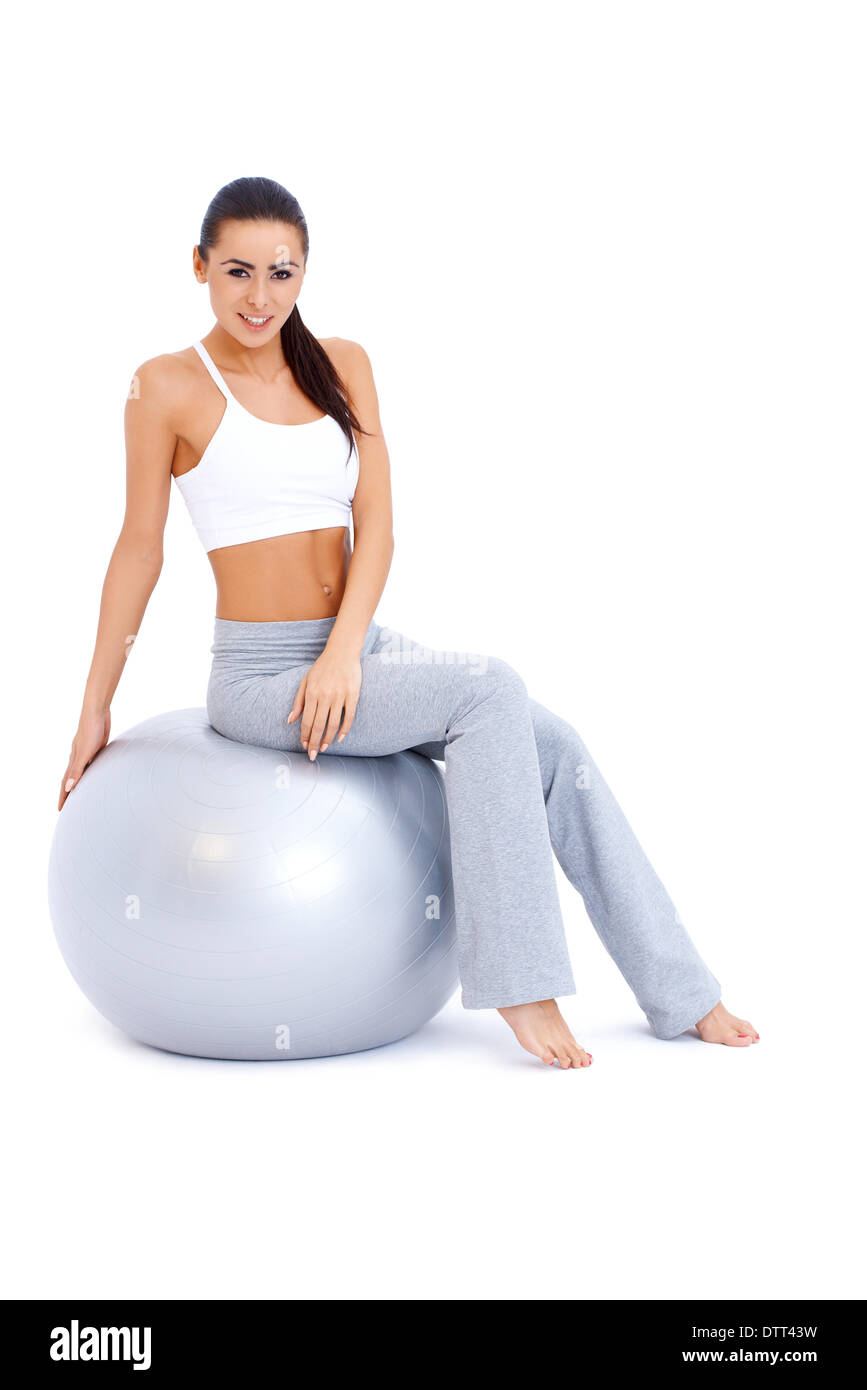 Athletic woman relaxing on fitness ball Stock Photo