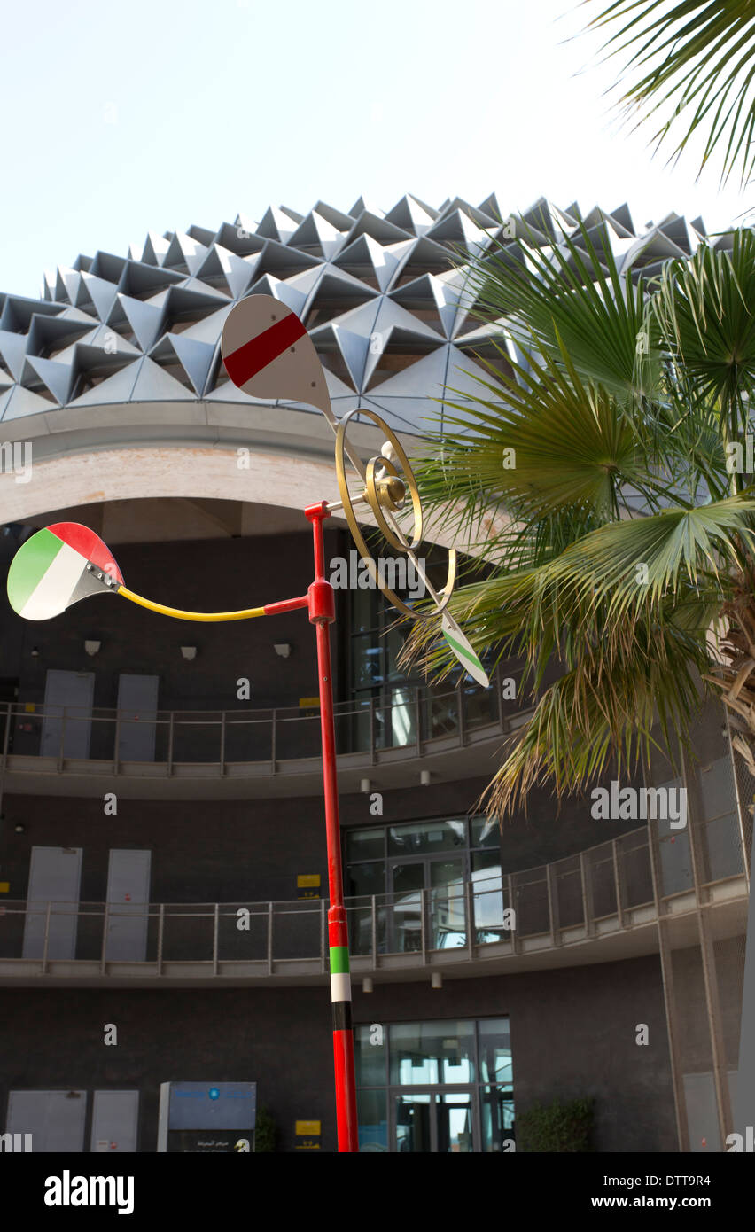 A view of buildings and a wind mobile in the carbon free city of Masdar City, near Abu Dhabi in the UAE Stock Photo