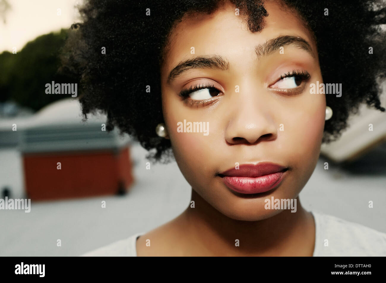 Mixed race woman arching an eyebrow Stock Photo