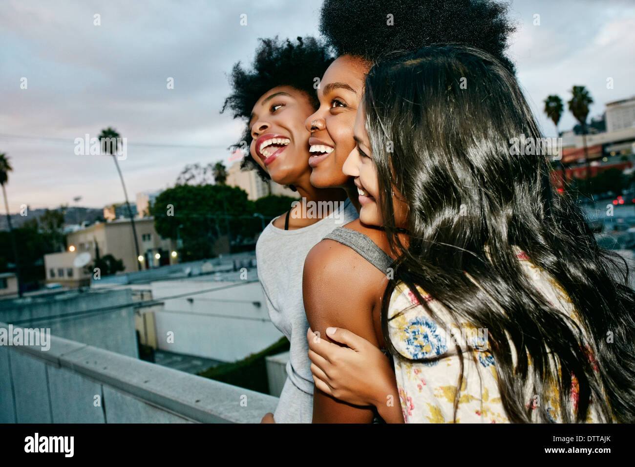 Women laughing together on urban rooftop Stock Photo - Alamy