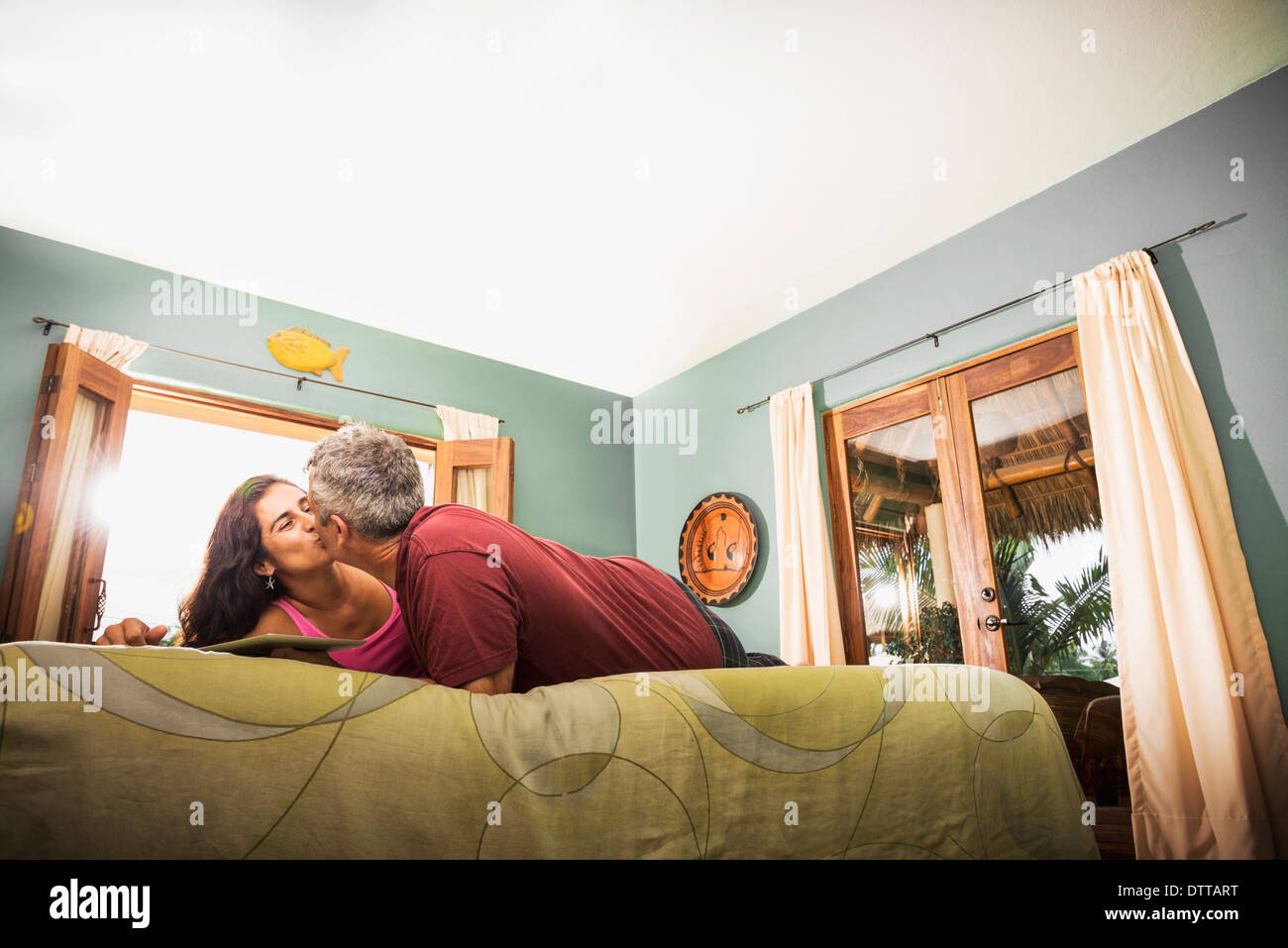 Couple kissing on bed Stock Photo