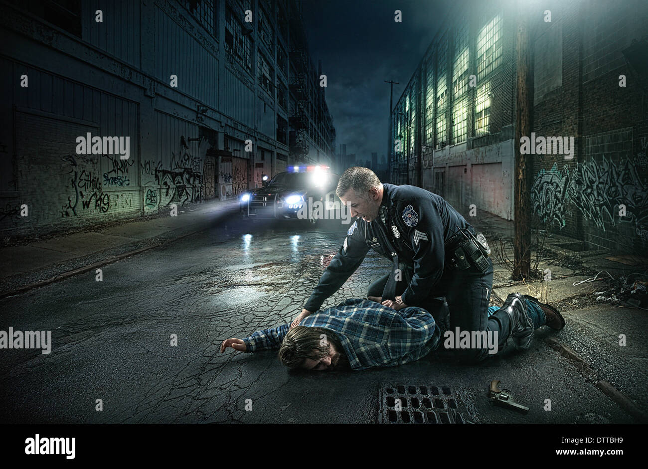 Policeman arresting man on city street Stock Photo