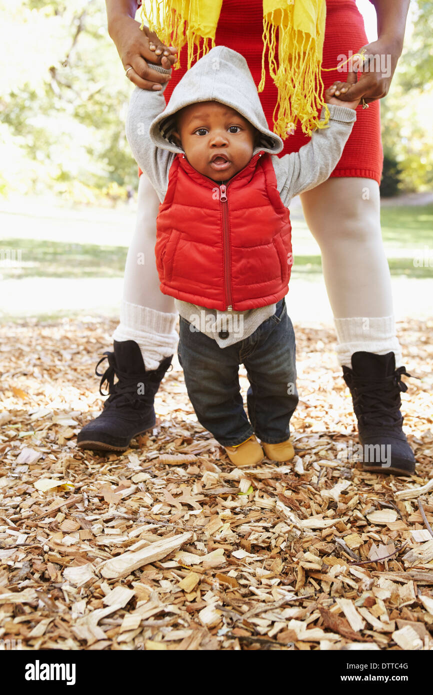 Black mother and toddler son playing in park Stock Photo