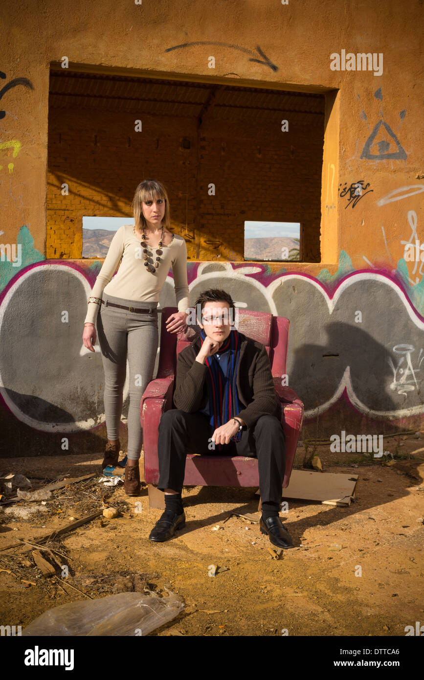 Posh looking people surrounded by industrial ruins Stock Photo