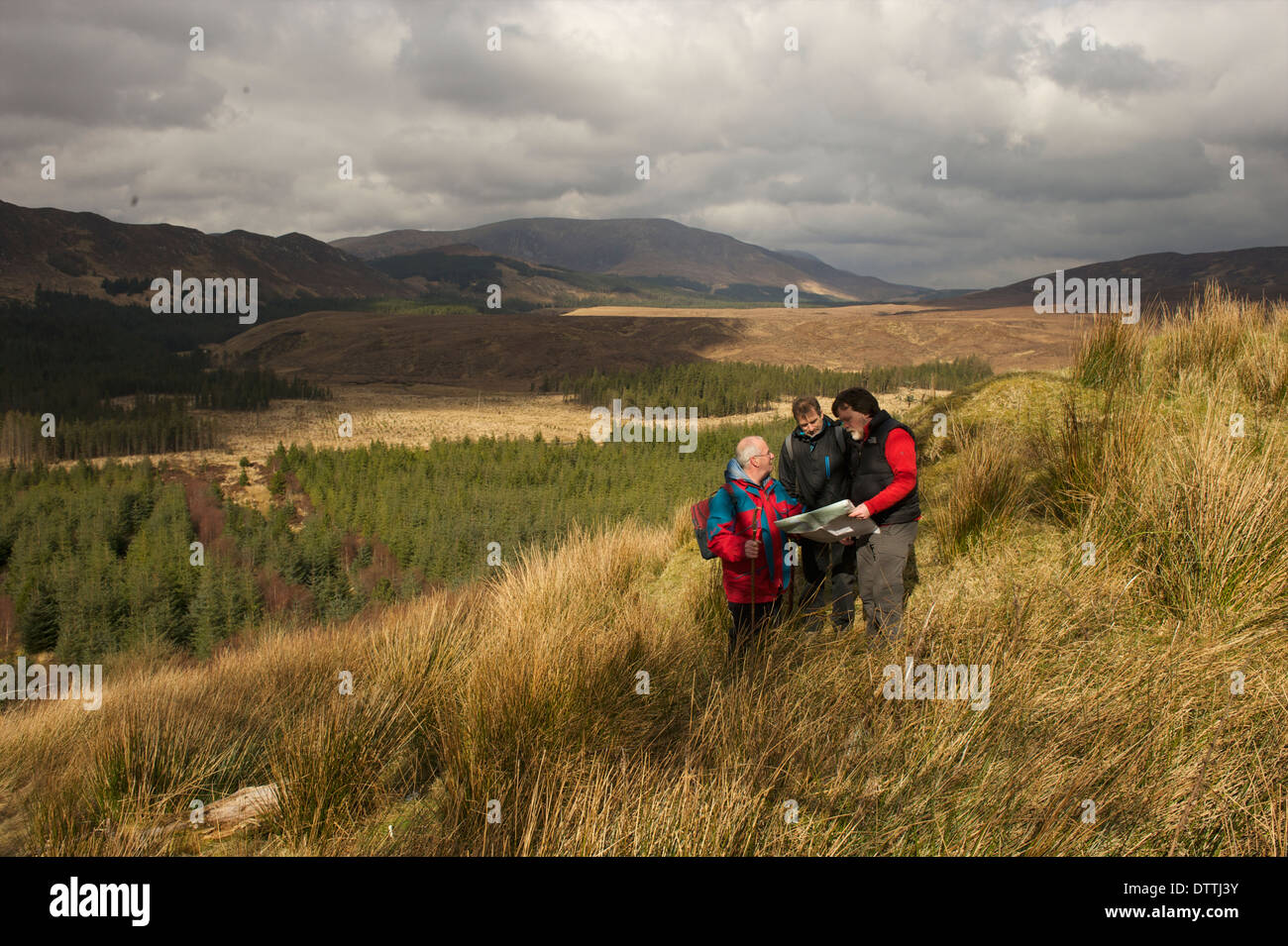 Walkers reading a map while walking in Furnace County Mayo, Ireland