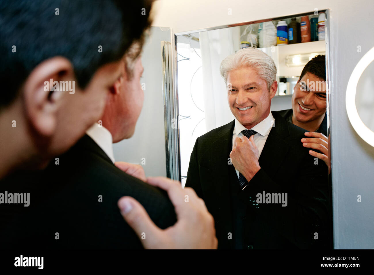 Homosexual couple smiling in mirror Stock Photo