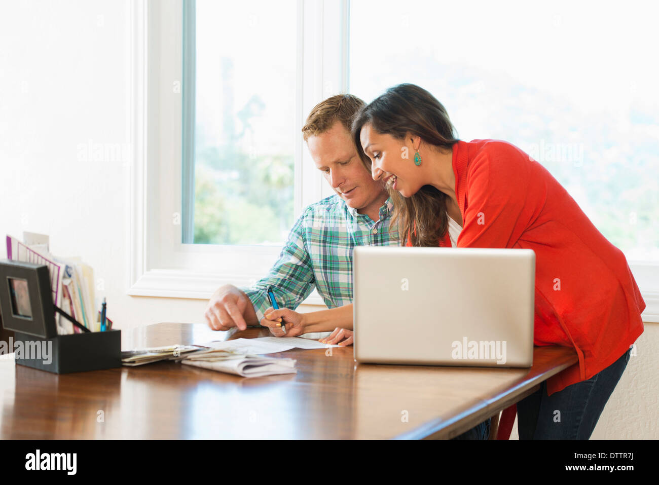 Couple shopping online at table Stock Photo