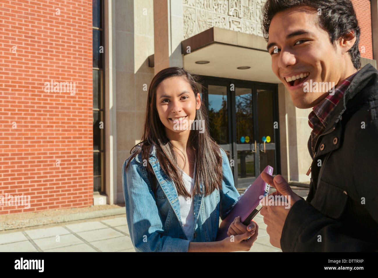 Students smiling on campus Stock Photo