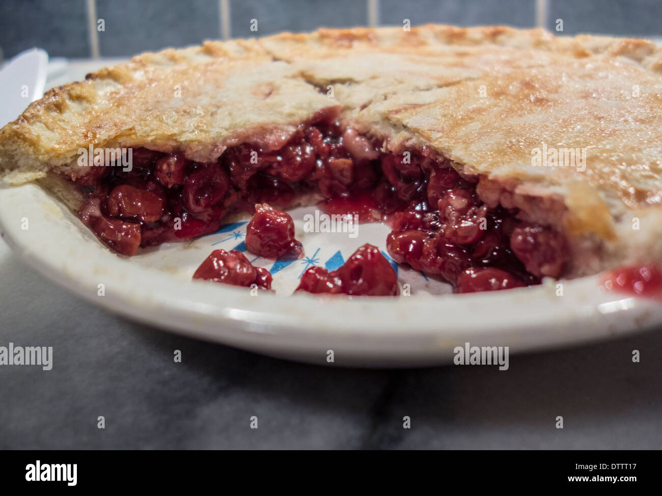 Homemade cherry pie, cut with cherries showing. Closeup. USA Stock Photo