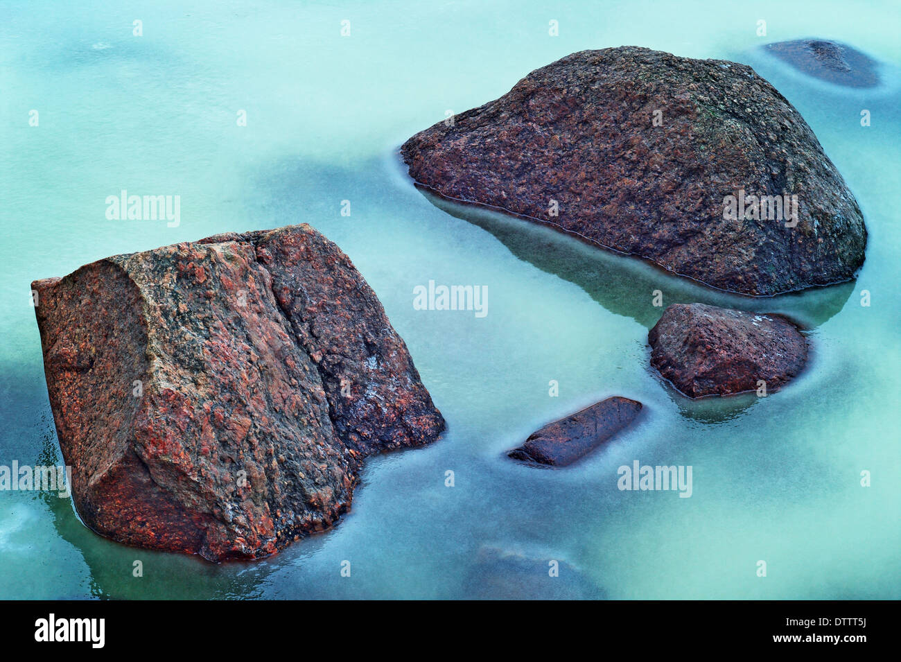 Stones immersed in frozen Vistula river. Poland. Stock Photo