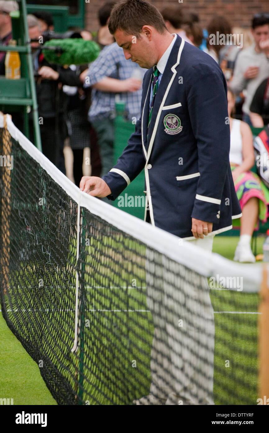 Wimbledon tennis line court umpire checks net hight people watching Stock Photo