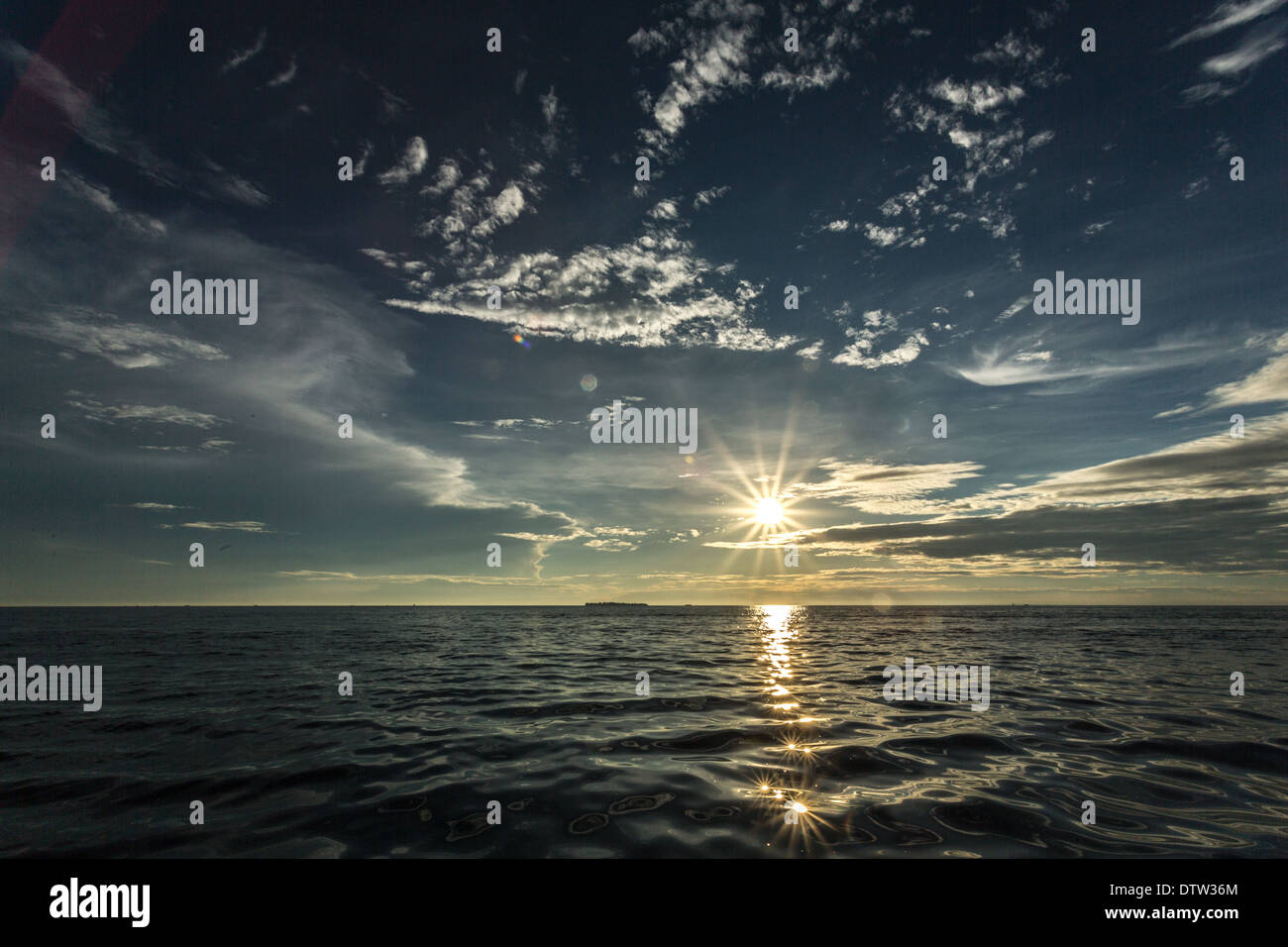 Sun setting the shores of the Indian Ocean in Zanzibar, Tanzania Stock Photo